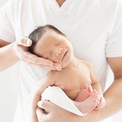 man holding newborn baby