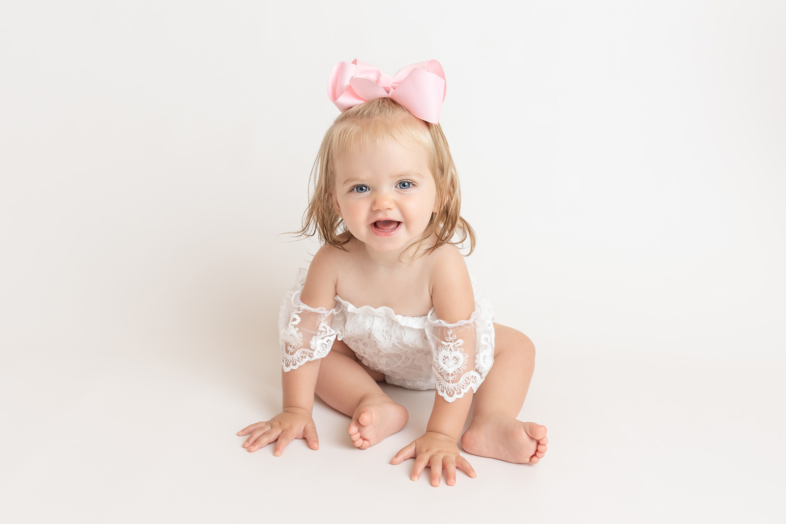 12-Month-Old-Carrie-Pfister-01 one year photo session with baby girl wearing pink bow