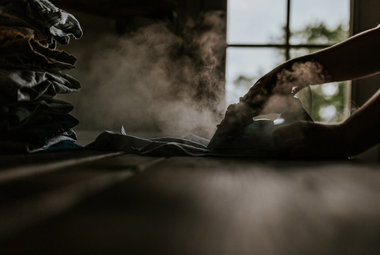 Low light photo of a person ironing