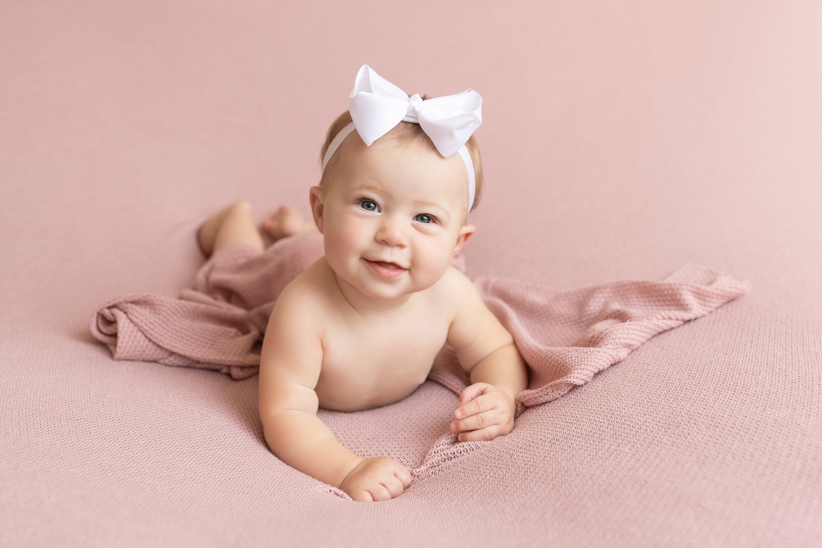 6-Month-Old-Carrie-Pfister-03 Baby milestone sessions for 6 month old girl smiling with pink blanket