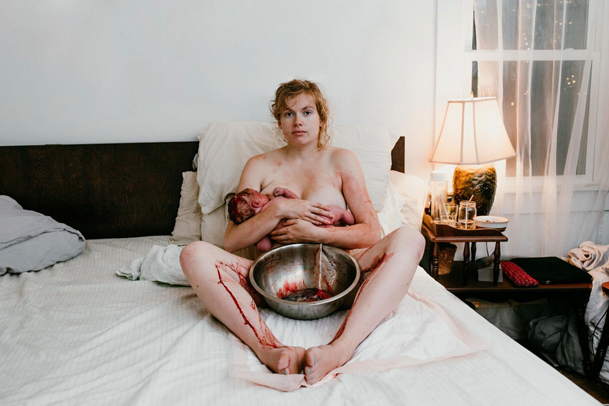 Screenshot Hanna Hill best birth photographer mom holds newborn baby on bed