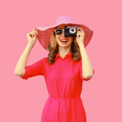 Female photographer on pink background with best photography products page
