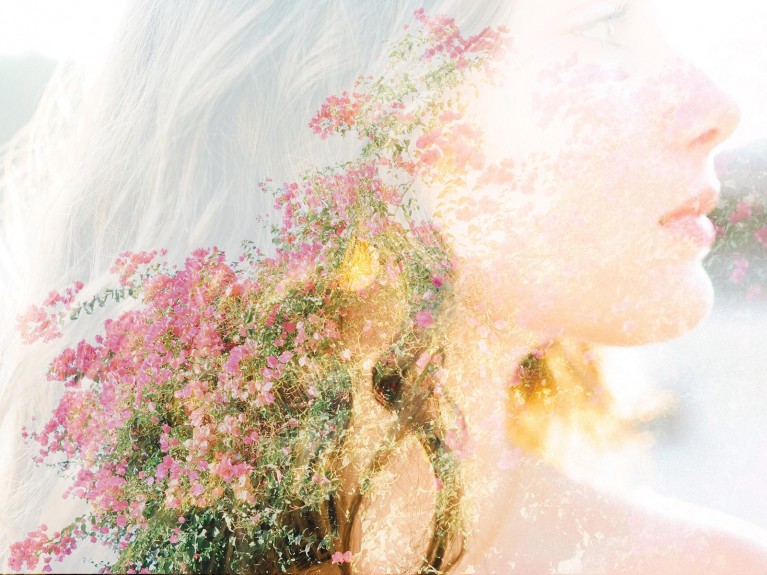 Creative double exposure of girl's hair and flowers