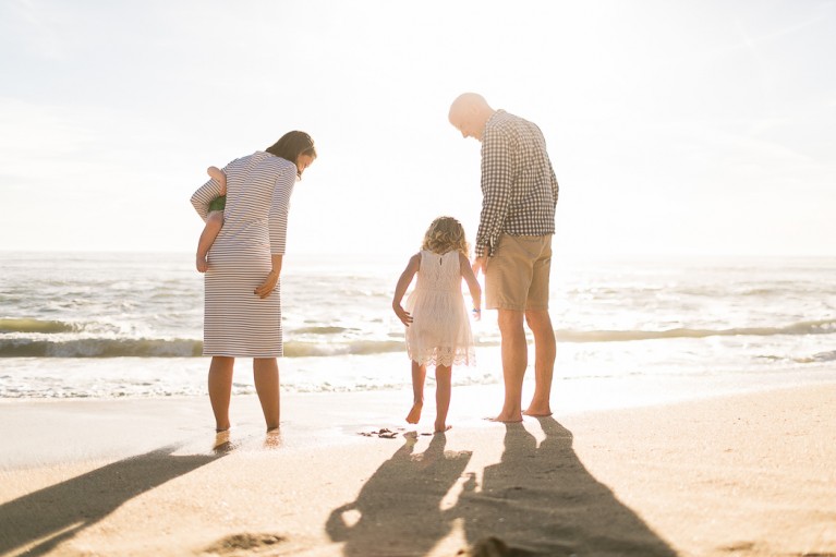 backlit family portrait on the beach by Kristin Dokoza