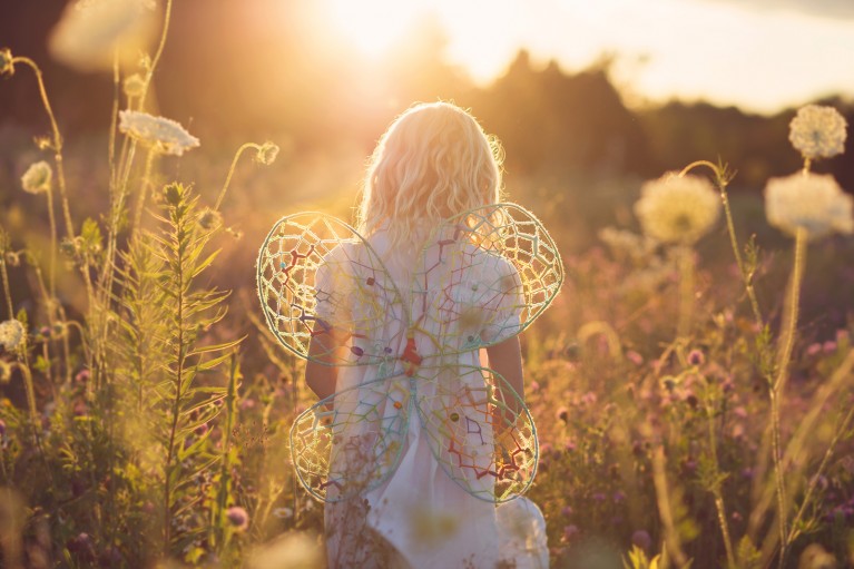 backlit photo of girl wearing DIY wings by Amy Lockheart