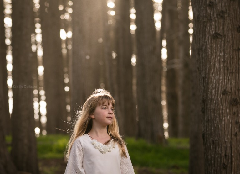 backlit photo of young girl by Kristin Dokoza