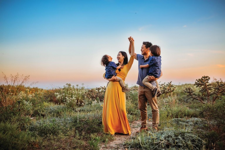 A family poses for a photo at blue hour