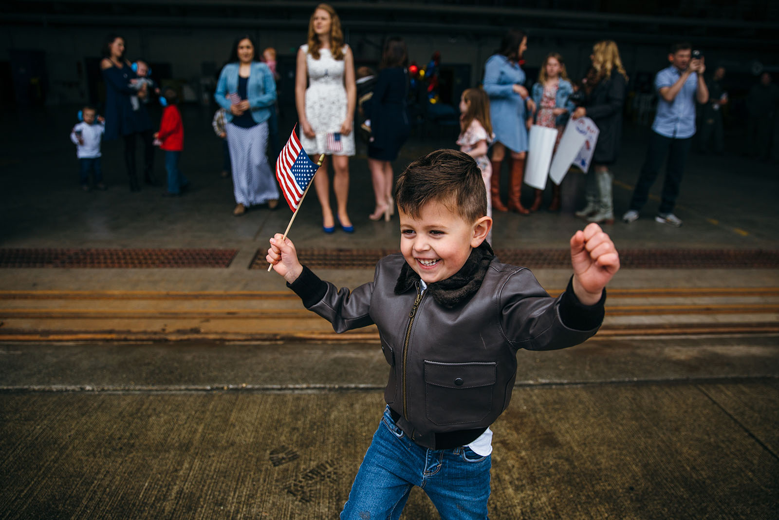 A little boy waits for his father at a military homecoming