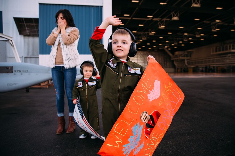A little boy waits for his father at a military homecoming