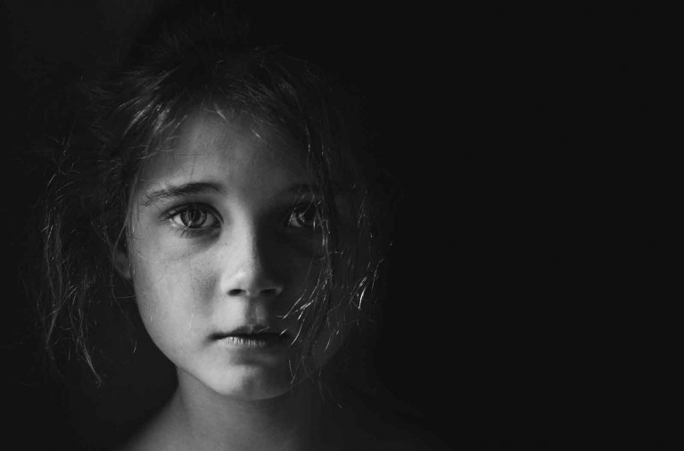 Emotive black & white portrait of child's face by Helen Whittle