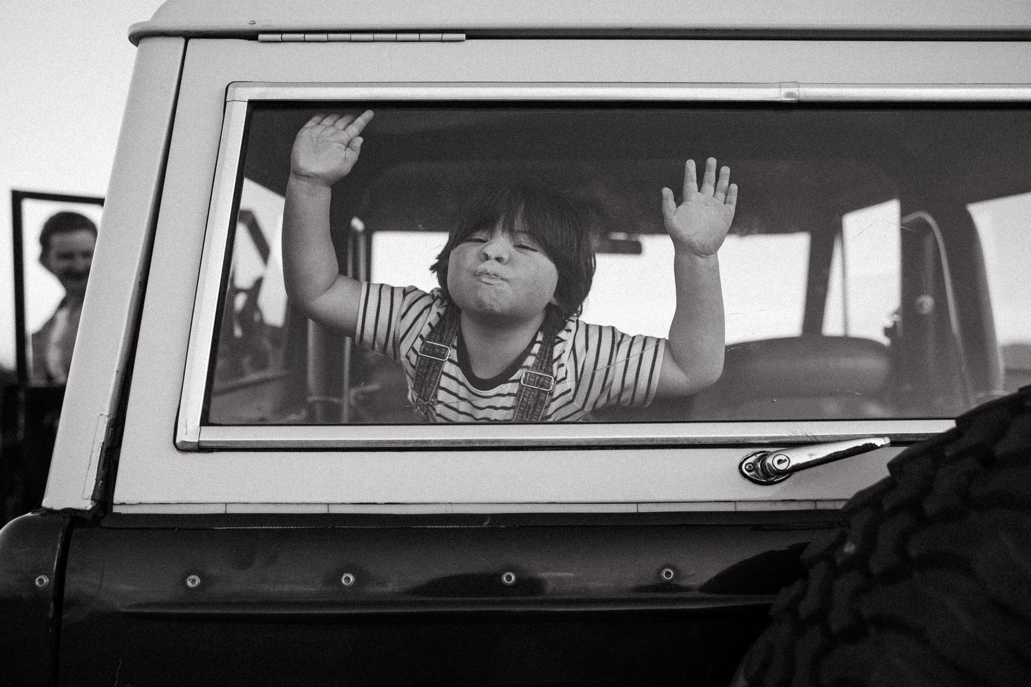 Raihna + Family Photo of child with face against car window