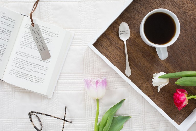 Flat-lay image of coffee and a book