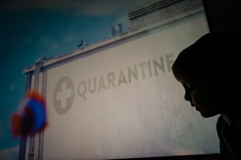 Silhouette of boy in front of quarantine sign during family documentary photo session