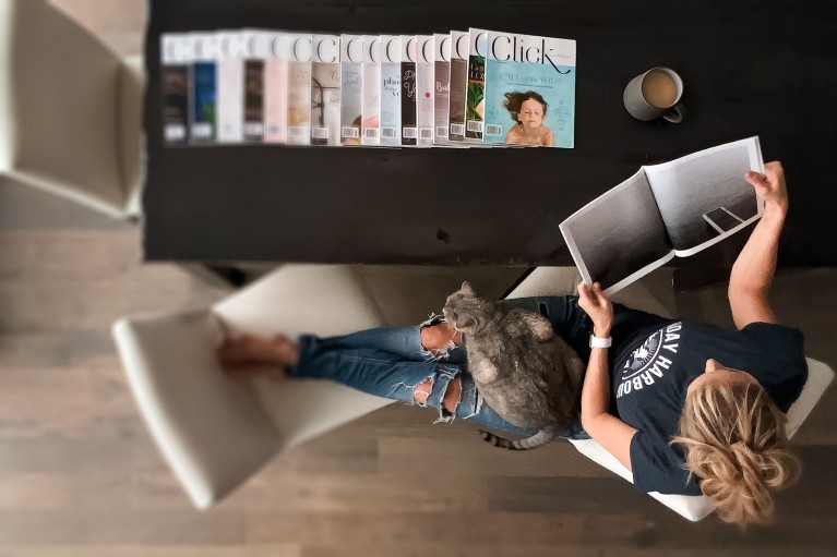 Woman reading Click magazine, shot from above