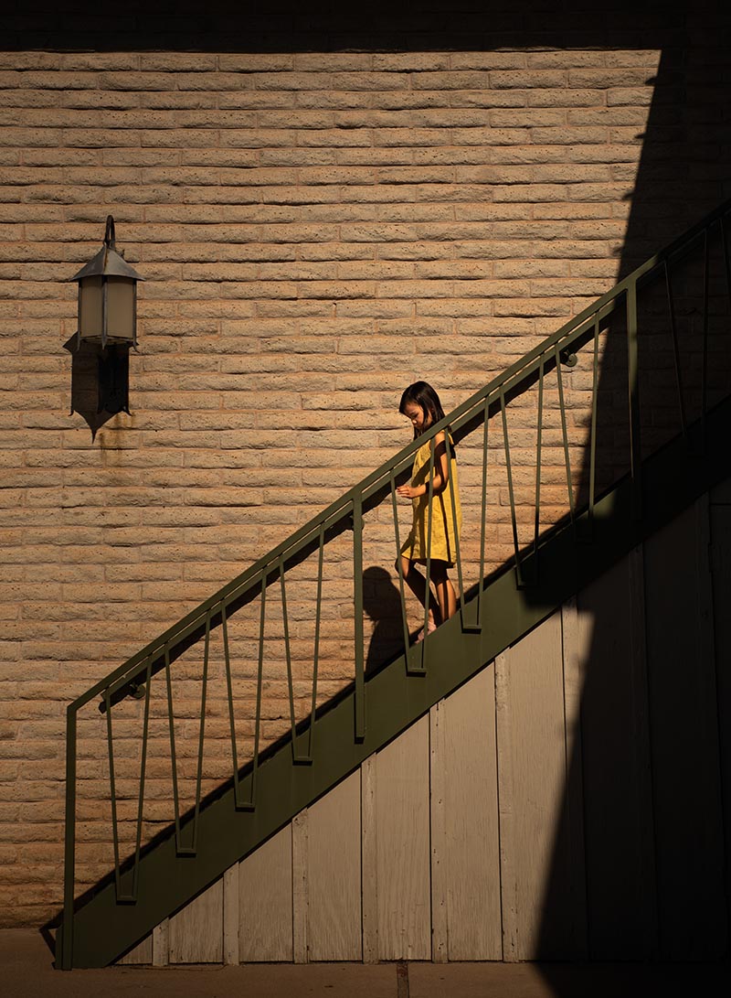 dangerfield-mentor-article girl walking down stairs in dramatic light