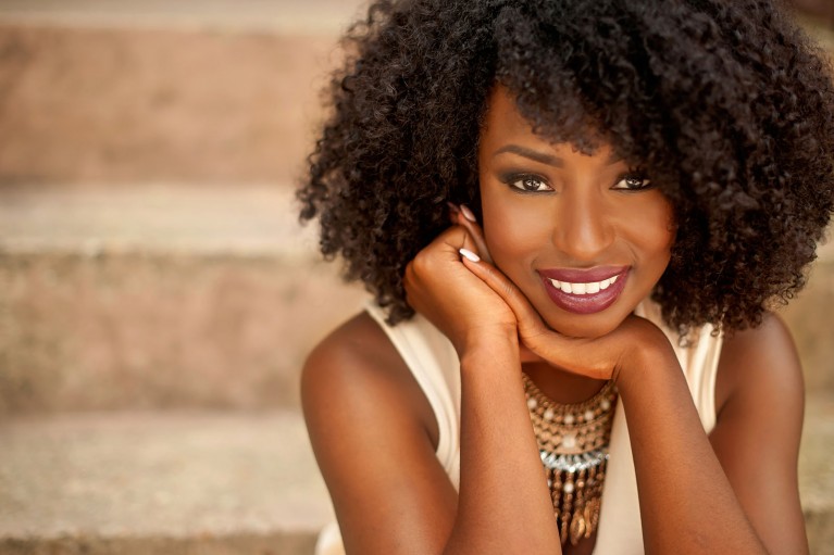 Lifestyle business portrait of a Black woman sitting on stairs by Danielle Finney