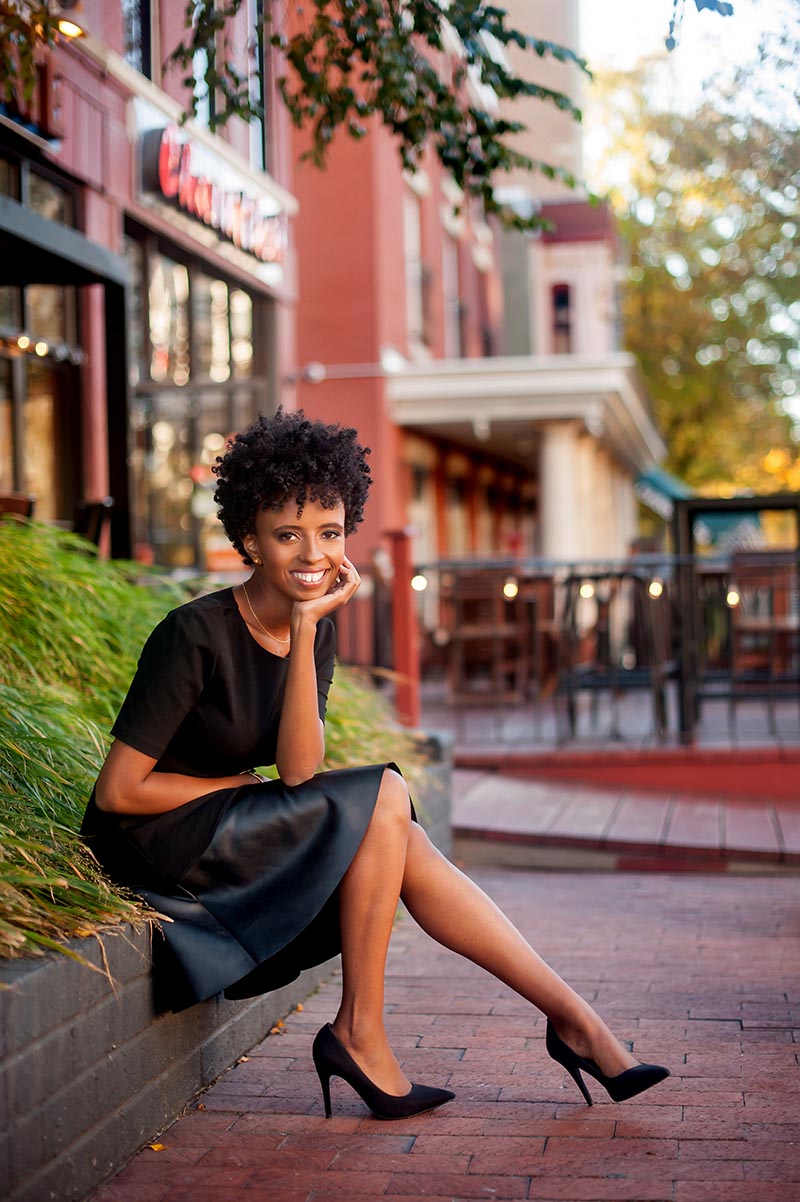 Danielle-Finney-lifestyle-business-portraits-3 Lifestyle business portrait of a Black woman sitting on brick ledge in city