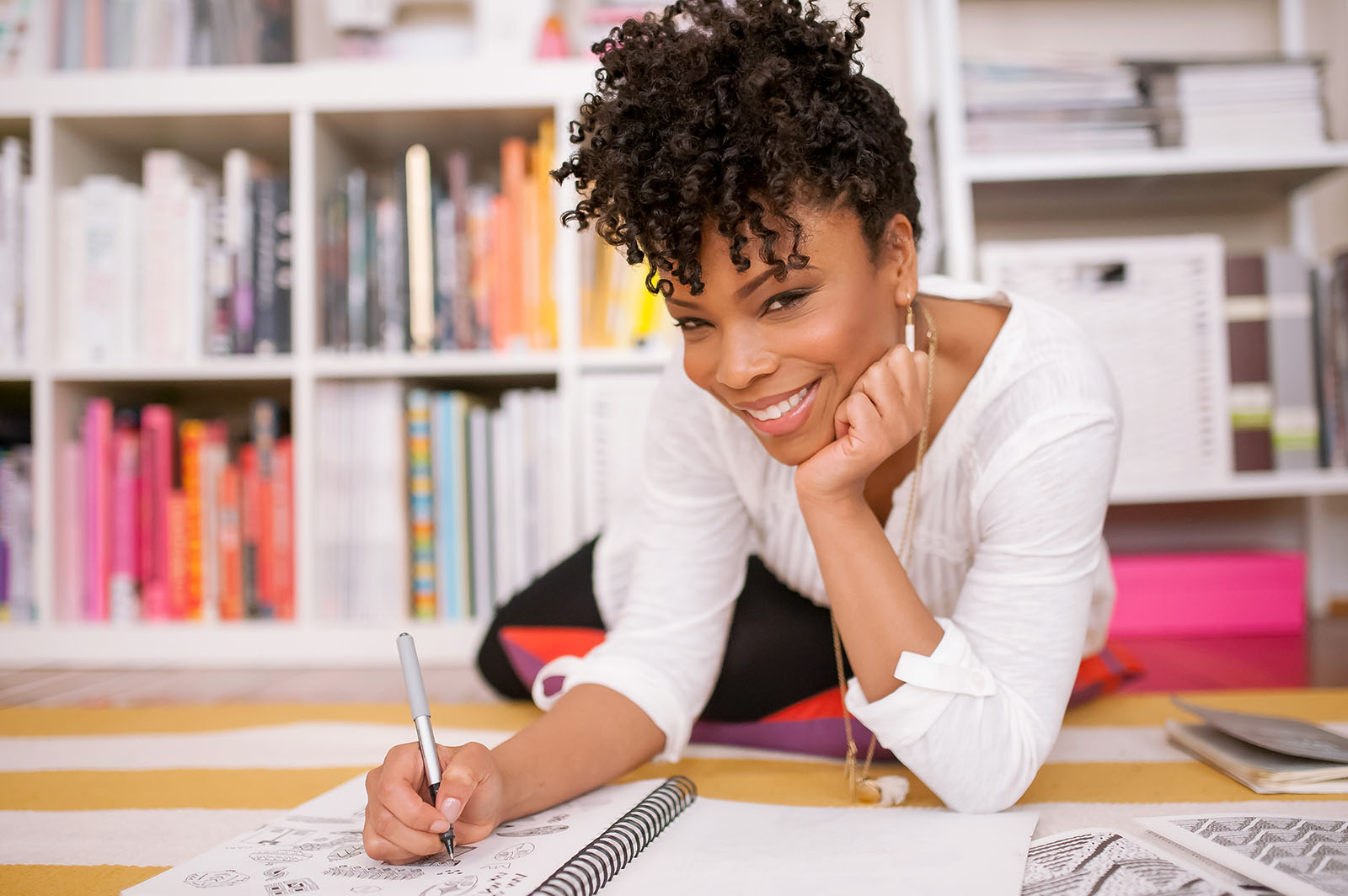Danielle-Finney-lifestyle-business-portraits Lifestyle business portrait of a Black woman writing in notebook by Danielle Finney