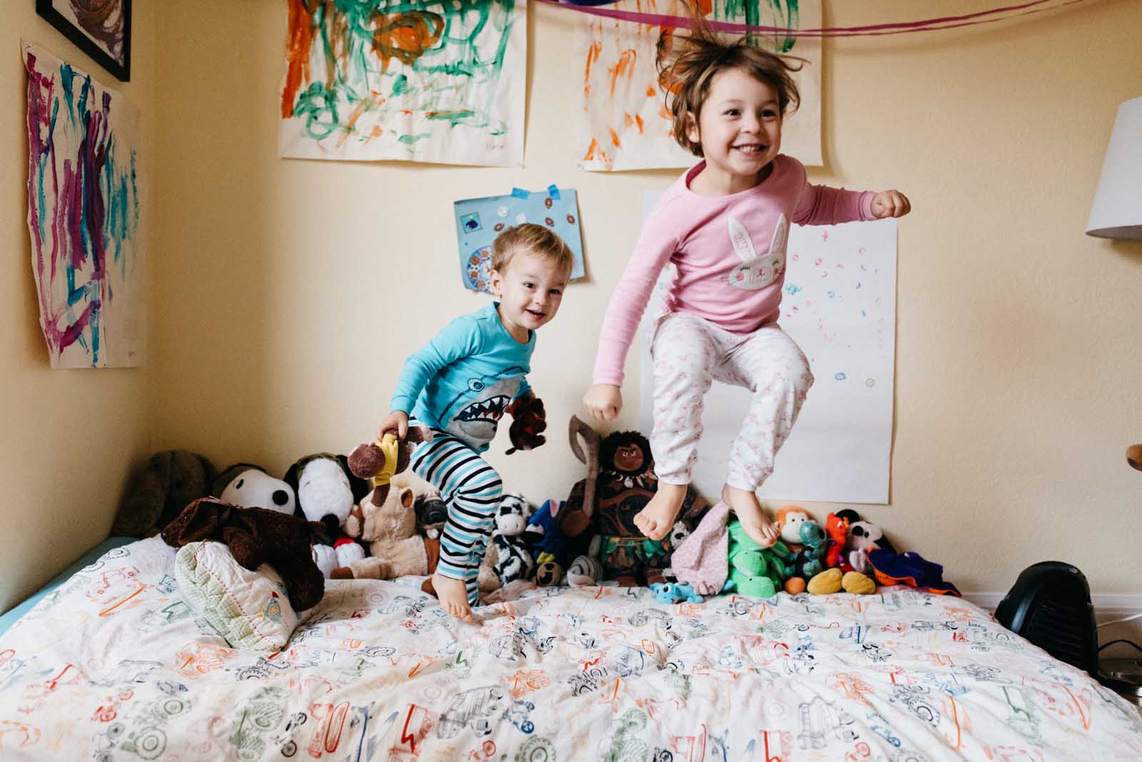 Kids jumping on bed day in the life session of photography