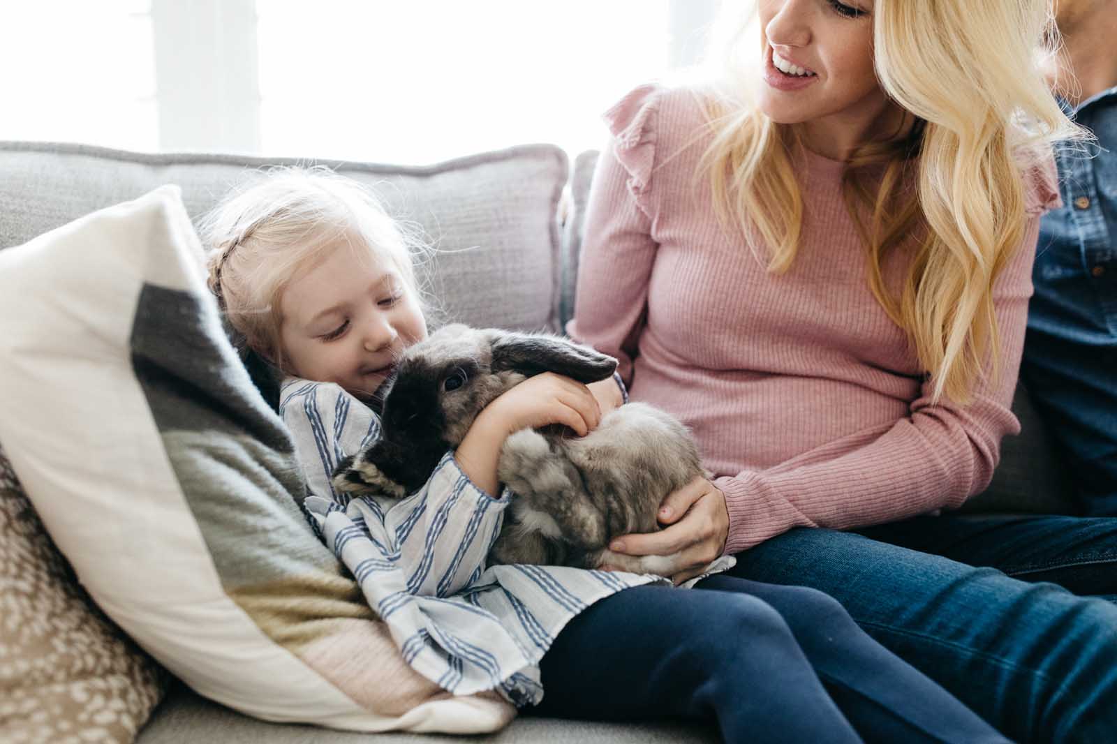 A girl holds a rabbit during day in the life photos