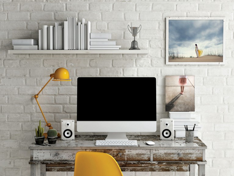 distressed desk against a white brick wall