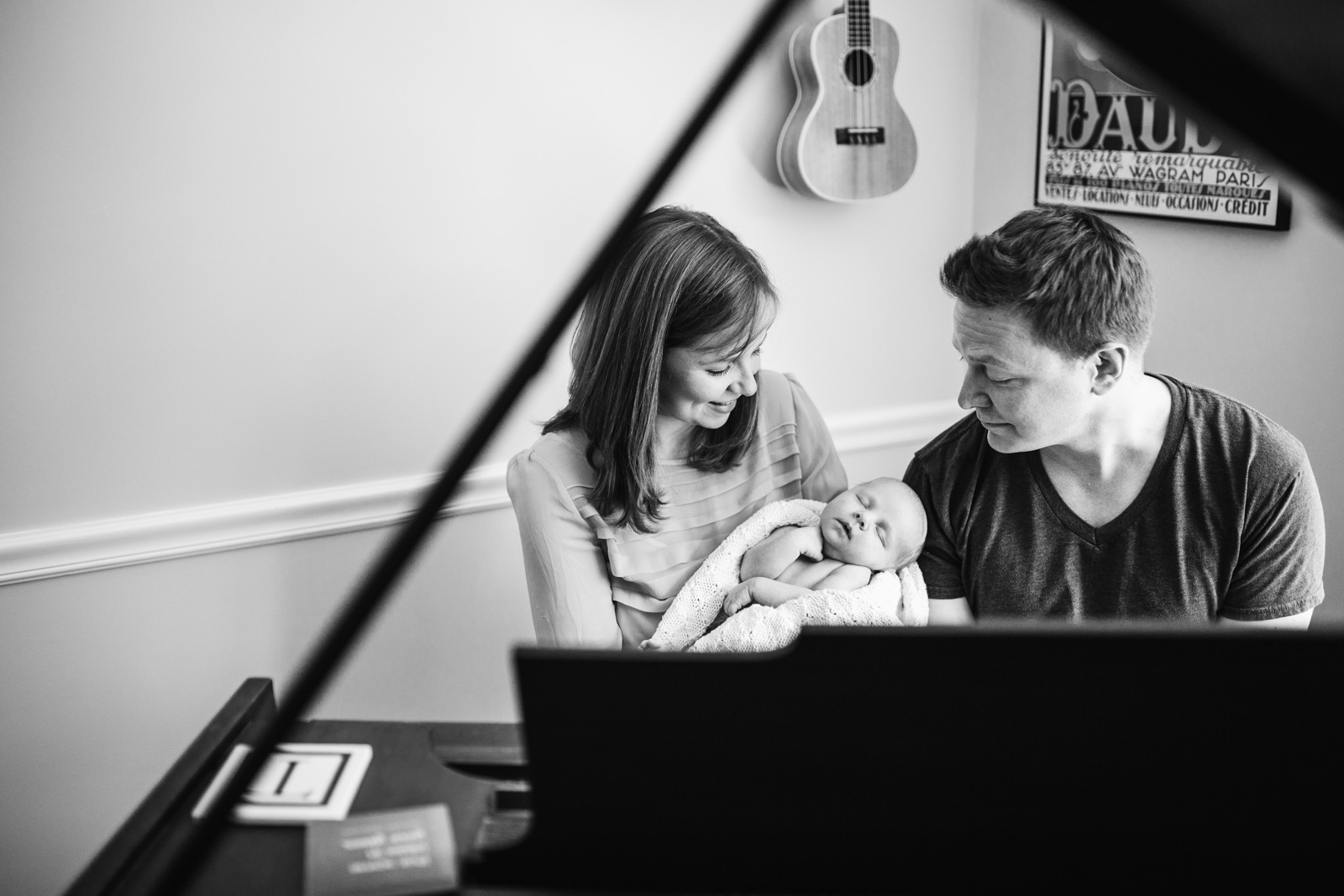 A couple at piano with newborn, attract ideal photography clients