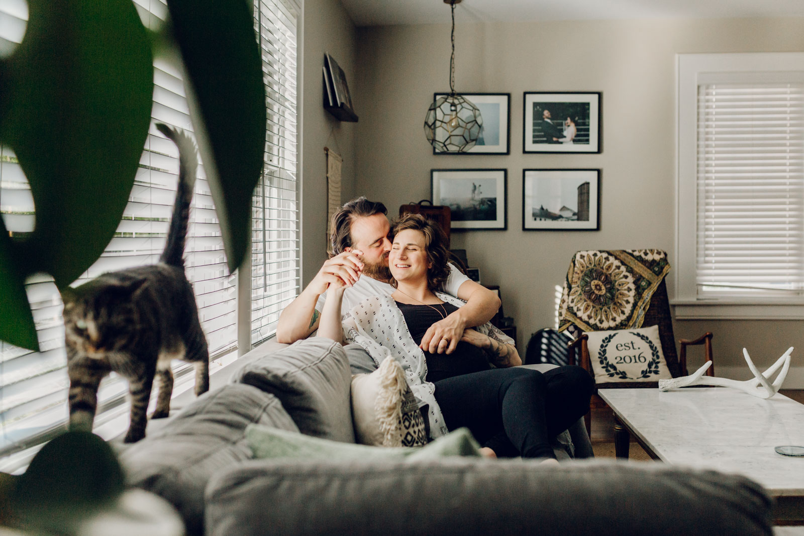 Lifestyle maternity photo of couple at home relaxed