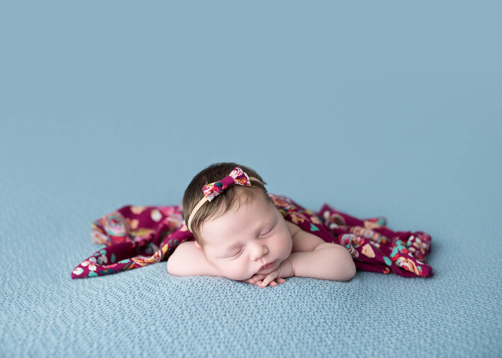 Newborn baby on blue blanket