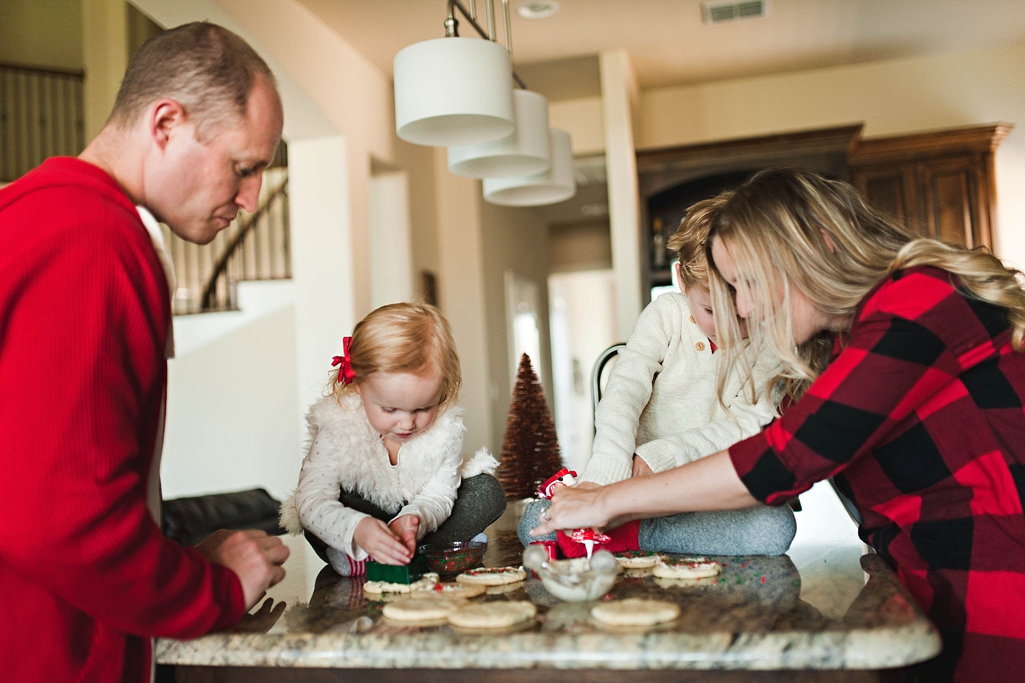 family making Christmas cookies by Erica Williams