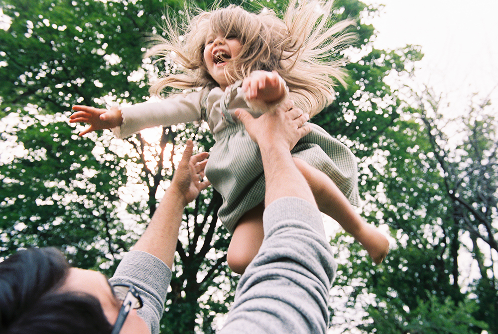 family_photography_on_film_brooke_schultz22 film photography photo of dad throwing little girl in air