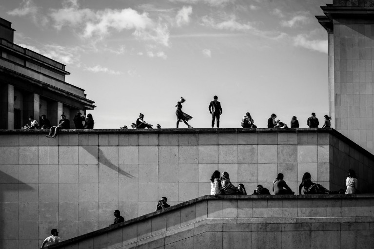 People silhouetted against sky