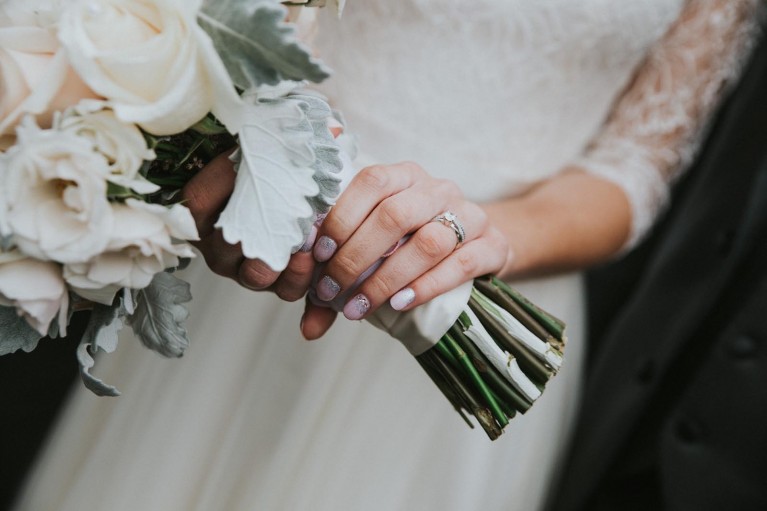 A human element to photographing details is a hand holding a bouquet.