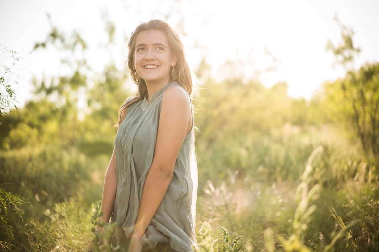 Me Ra Koh's daughter, Pascaline, smiling in a field