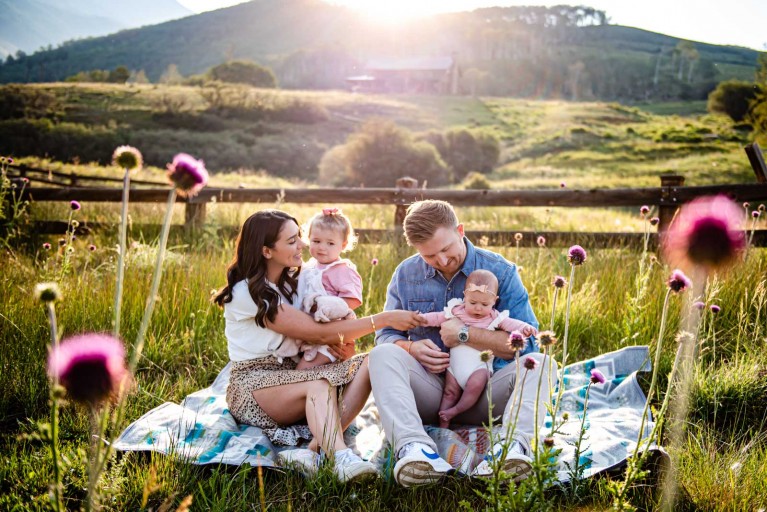 Environmental portrait of a family with mountains in the background