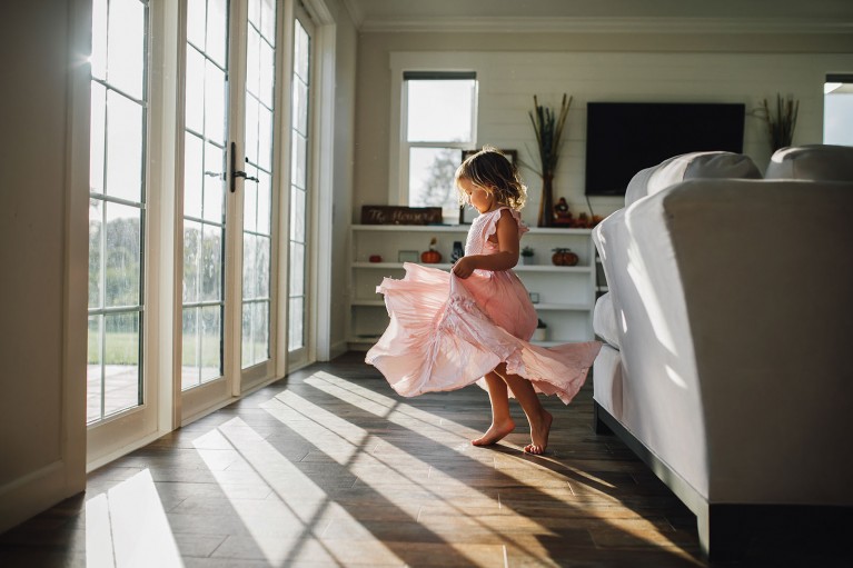 Creative use of window light, little girl twirling