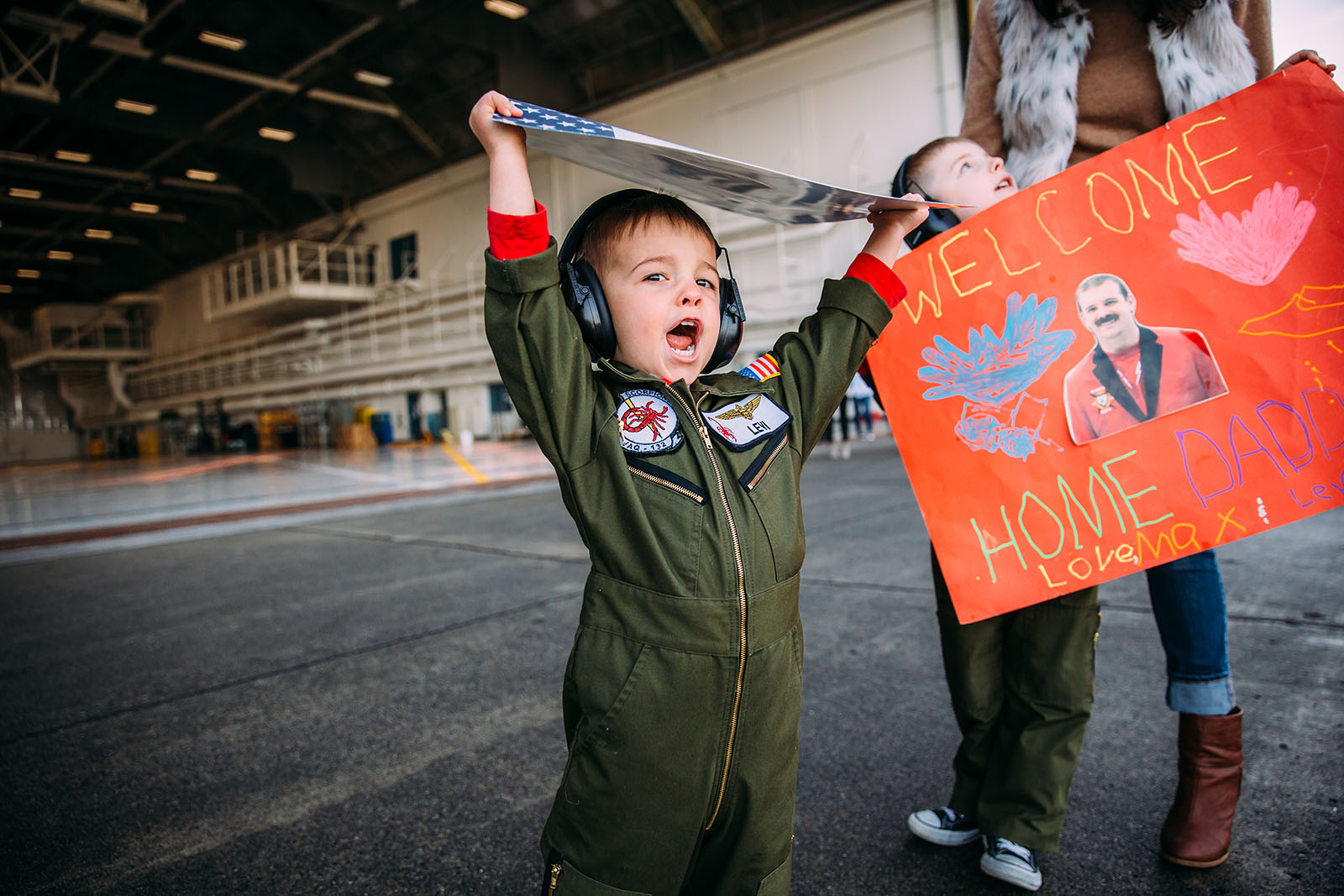 A little boy waits for his father at a military homecoming