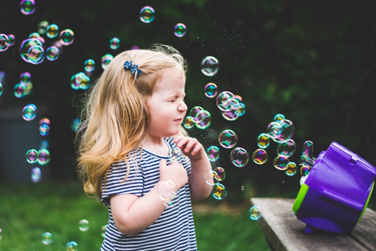 photo of bubbles blowing in girls face by Francesca Russell