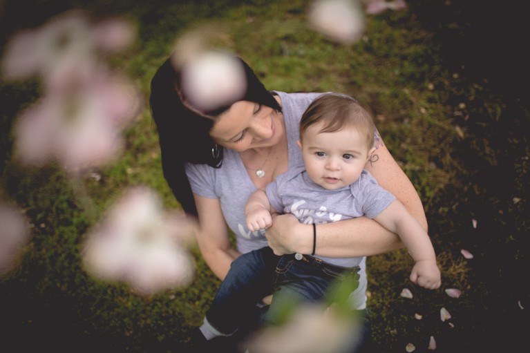 photo of mom holding child by Cambria Bailey