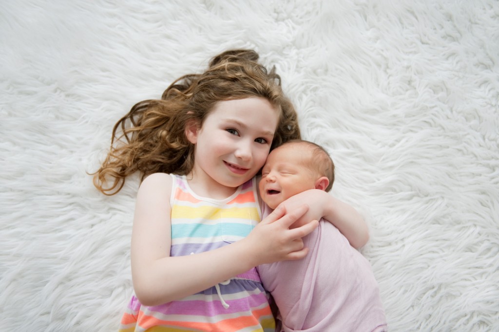 picture of big sister with newborn baby by Shey Detterline