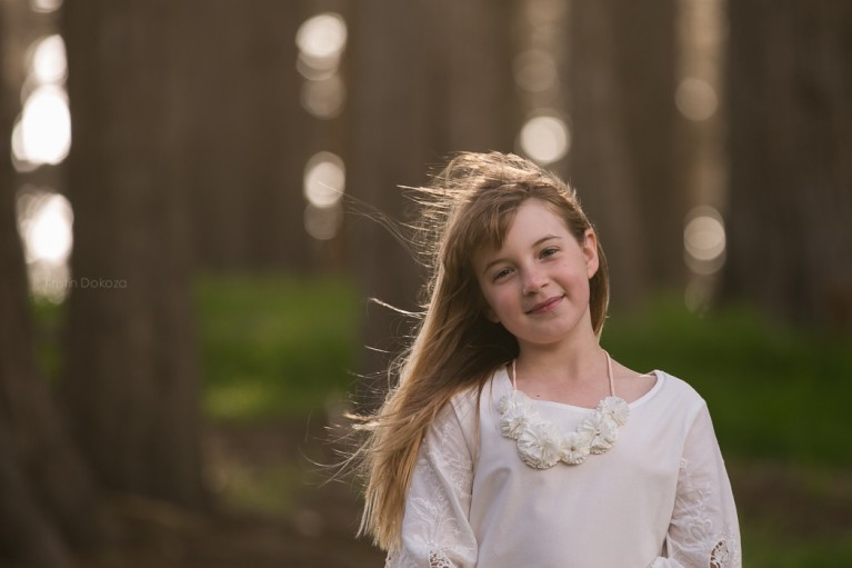 picture of girl smiling near trees by Kristin Dokoza