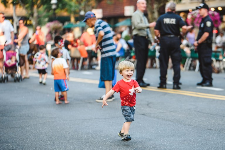 picture of kid in a red shirt running down the street by Francesca Russell