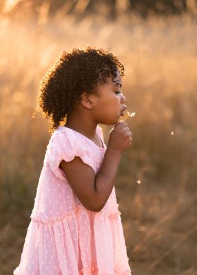 Play-Melissa-Miller-15 Young girl blows dandelion fuzz