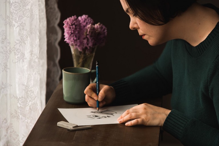 Photo of a female artist drawing