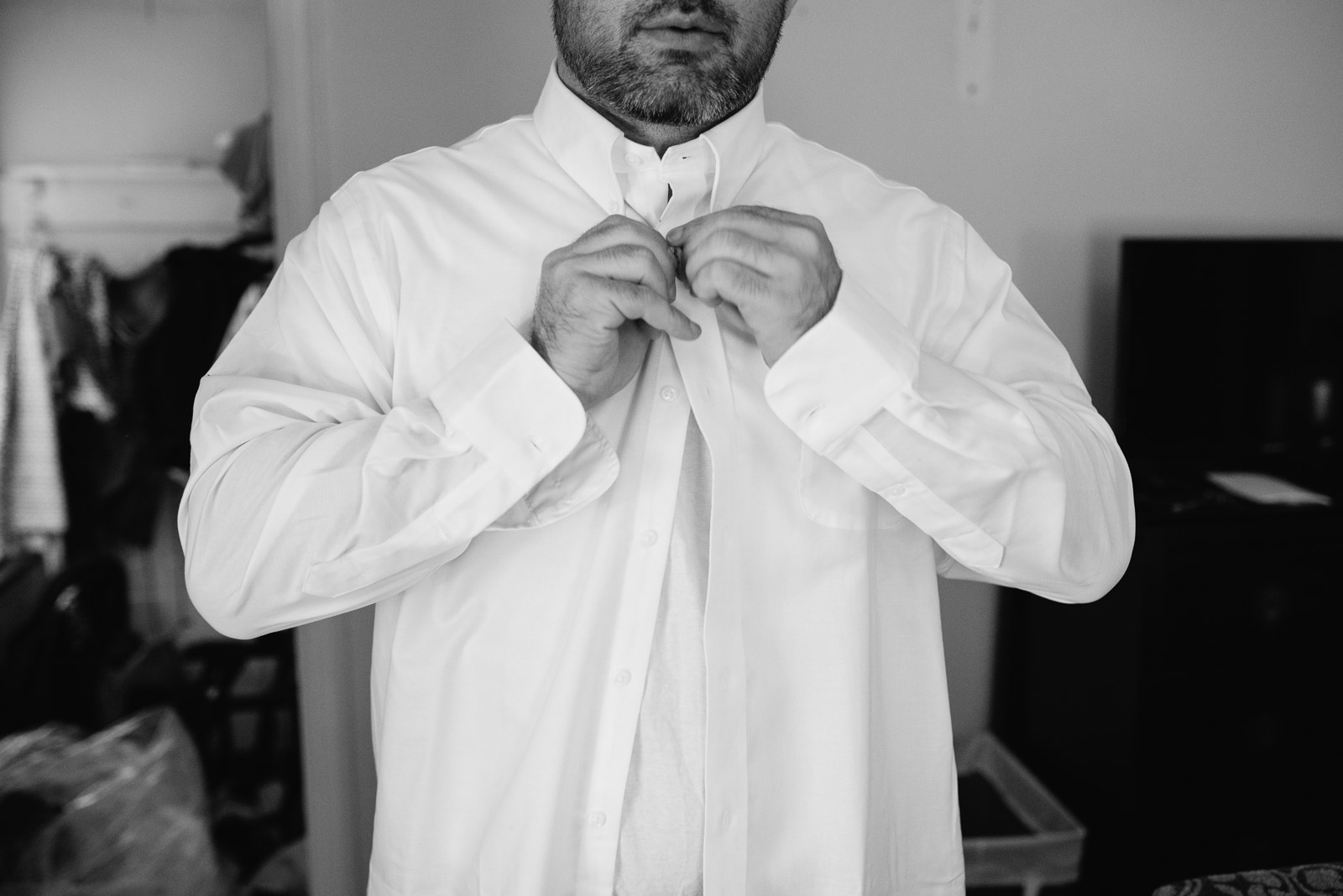 Second-Shooter-Blog-Click-by-Mariah-Fisher-14 A groom buttoning his shirt. Photo by a second photographer.
