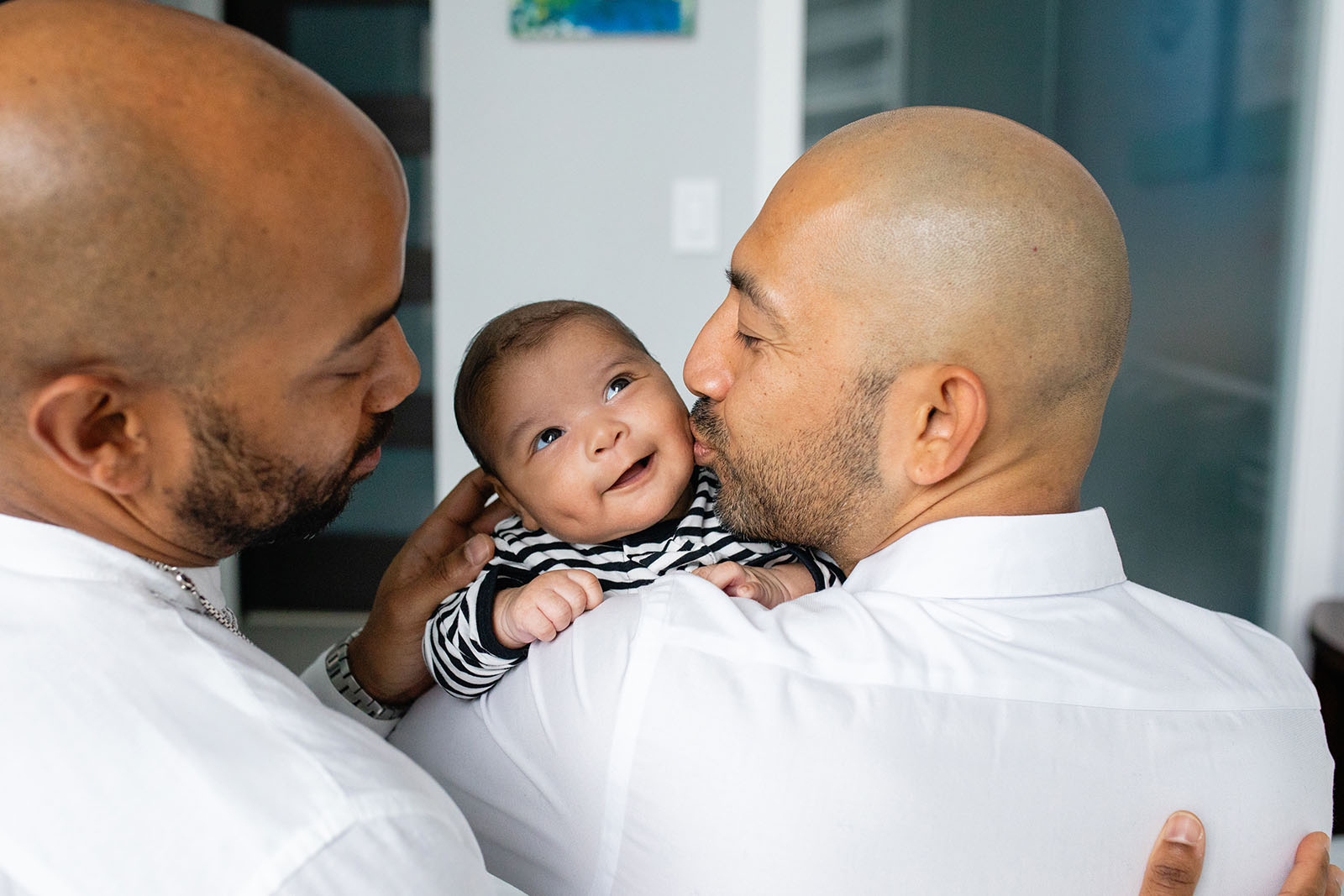 smiling-newborn-baby-being-kissed-by-her-fathers-on-cheek-Miami-Covid-safe-photo-session-Audrey-Blake-Photography 22 Dads kiss their baby during newborn photo session