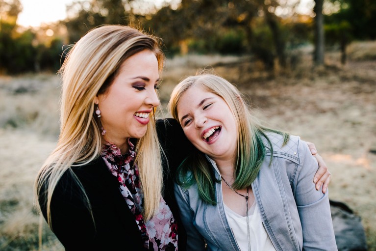 A mom and daughter laughing - How to get natural smiles in photos