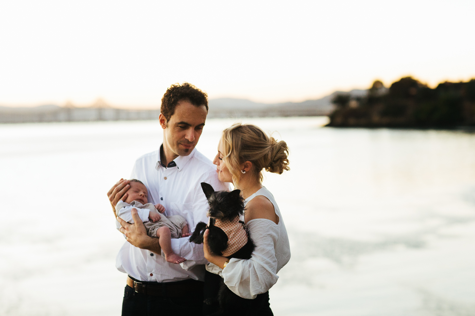 TarahPhotography-PointRichmond-27miles Travel photo of a couple holding a newborn and a dog in Point Richmond, California