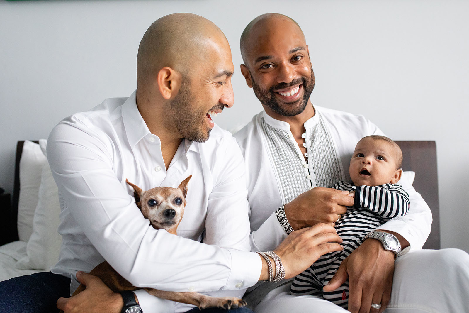 two-dads-and-their-baby-and-dog-posing-Miami-Covid-safe-photo-session-Audrey-Blake-Photography-with-dr-hansel-tookes 32 Smiling fathers hold newborn during pandemic photo session