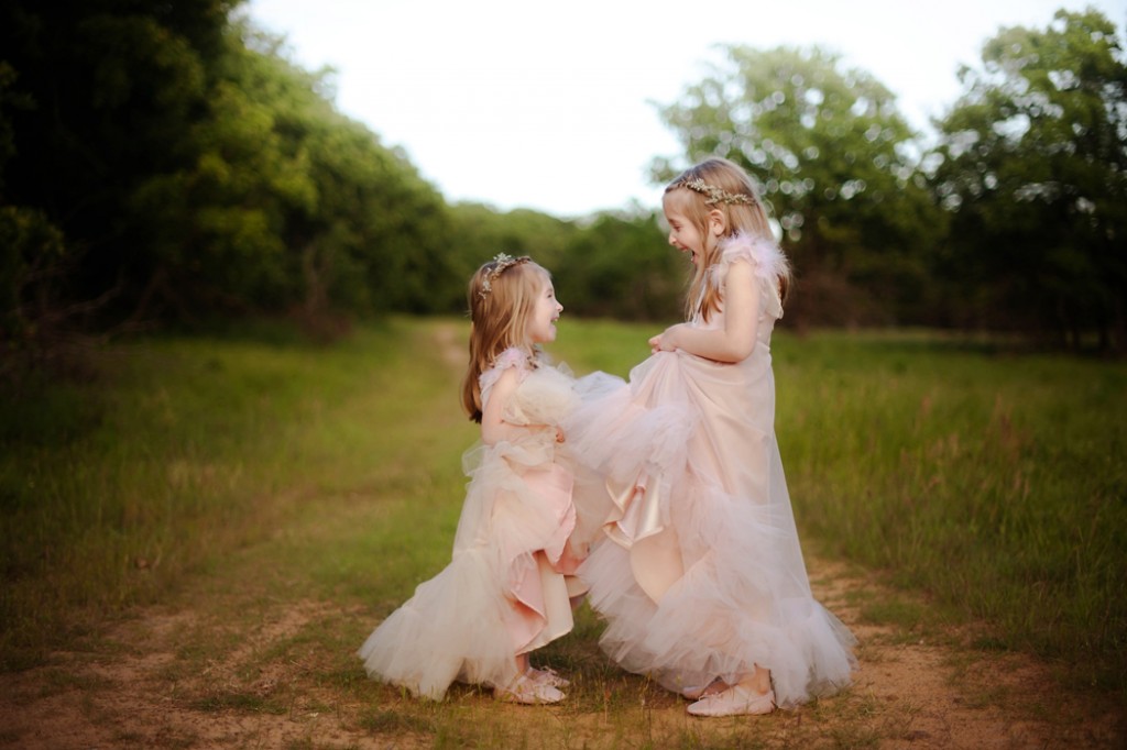 two girls in matching dresses in a field by Woodsy Wonders Photography